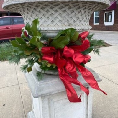 Linda Walker & volunteers decorate the downtown urns for Christmas.