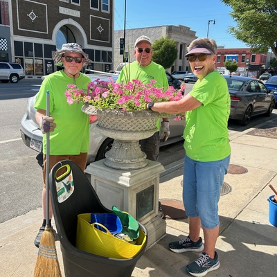 Fred Fourby, Bill Stobart, and Linda Walker planting petunias.