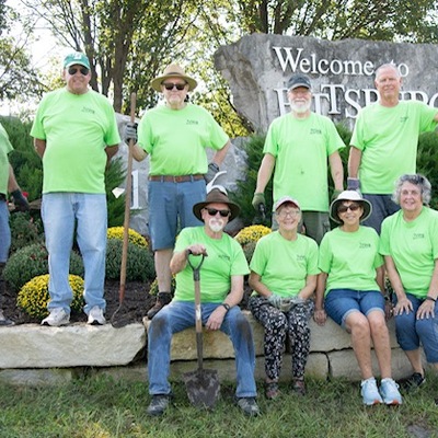 Planting Fall mums at the 20th St. & Bypass Welcome Sign