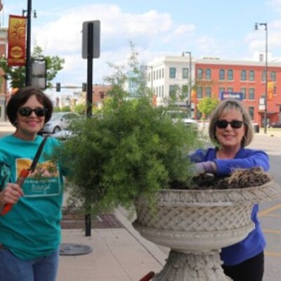 Marty Beezley & Marilyn Peterson planting ferns in downtown urns.
