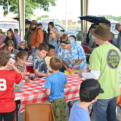 Michael Brewer, helping with children's art on Mother's Day weekend at the Farmer's Market